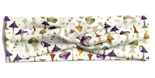 Green and yellow and purple cottagecore mushrooms on a beige twist headwrap headband for women
