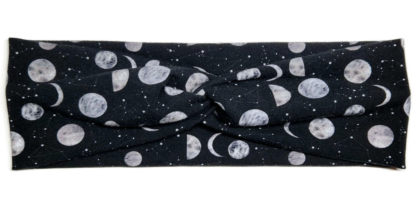 moons and constellations printed on a black twist headwrap headband for women