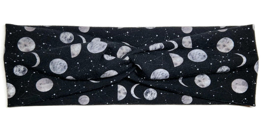 moons and constellations printed on a black twist headwrap headband for women