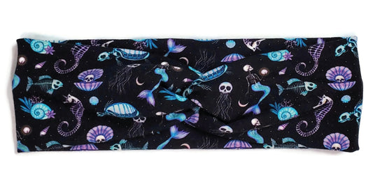 Spooky cute style purple and blue skeleton mermaids, seahorses, turtles, fish, Jellyfish and clams on a black twist headwrap headband for women