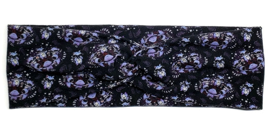 Purple pagan raccoons in a circle around pentagrams on a black twist headband for women