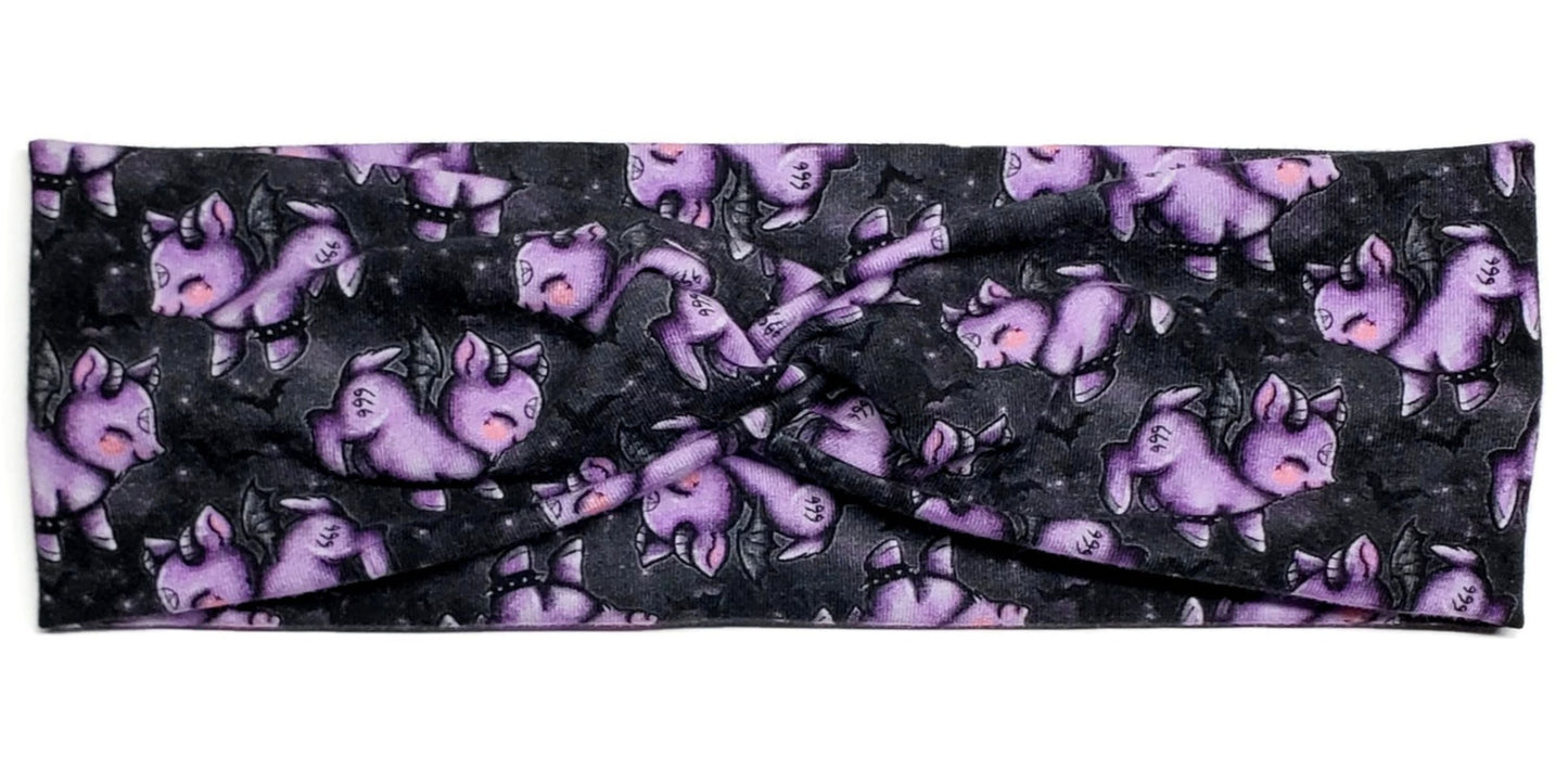 Pastel goth style purple goats with pentagrams and 666 surrounded by bats on a black cotton twist headband for women