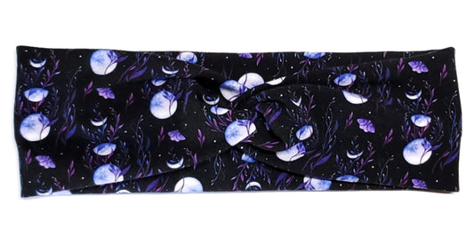 Dark cottagecore themed moon phases and purple moths on a black twist headwrap headband for women